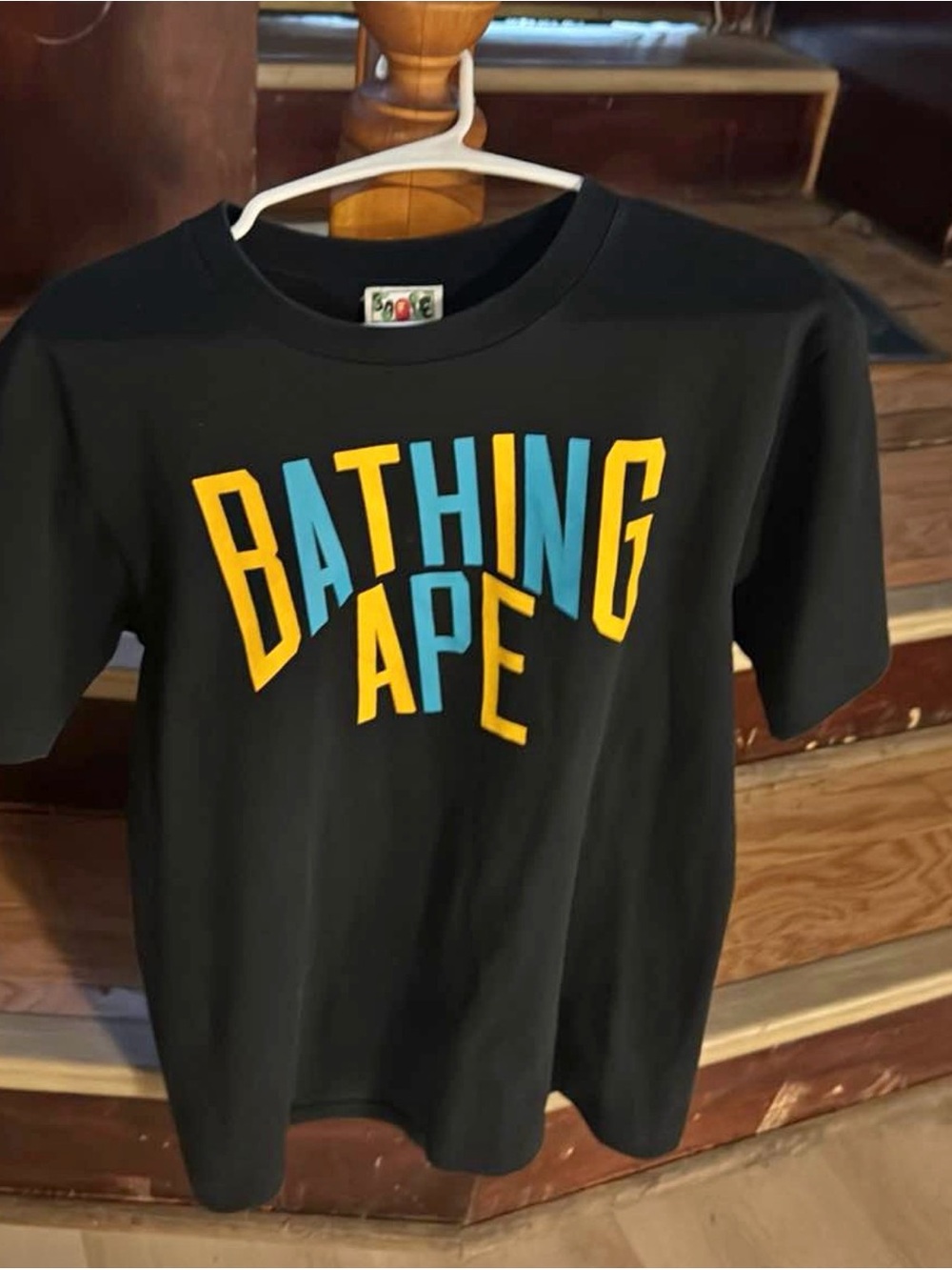 BAPE Short Sleeve Logo Tee in Black with Yellow & Blue Lettering